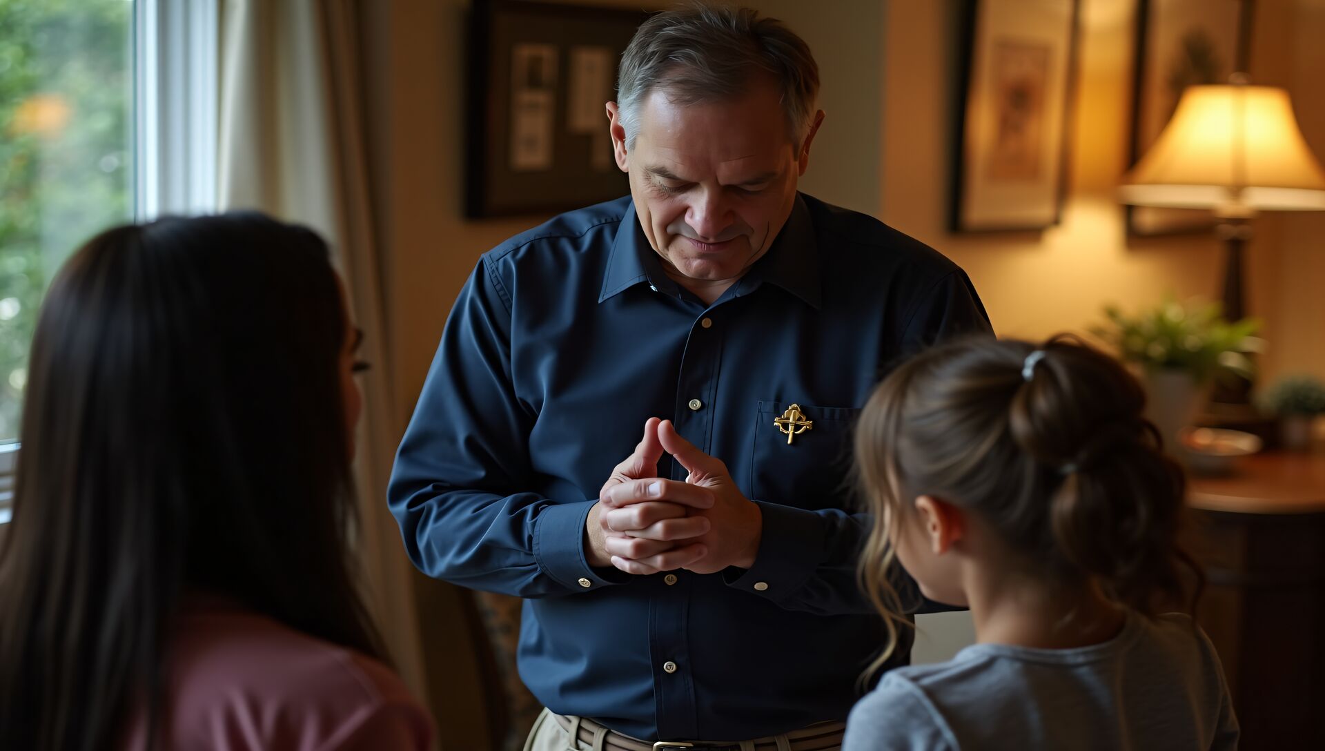 A chaplain praying with a family at home